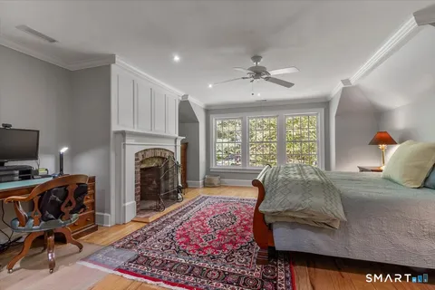 a bedroom with furniture and a fireplace