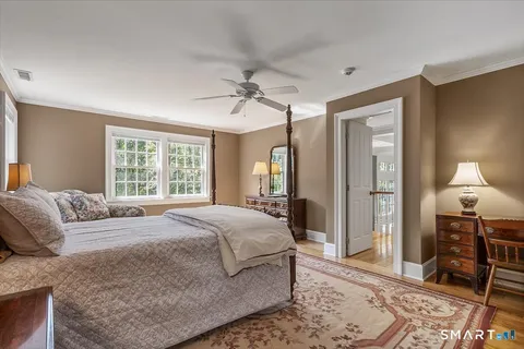 a bedroom with a large bed and a window