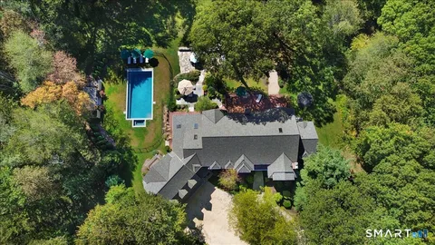 an aerial view of a house with a yard basket ball court and outdoor seating