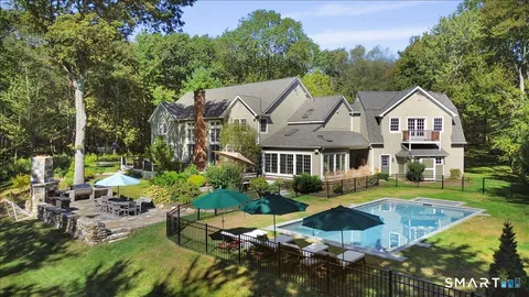 a view of a house with swimming pool and garden