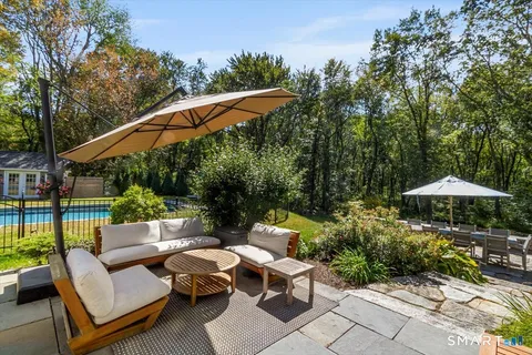 a backyard of a house with a yard and outdoor seating
