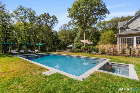 a view of a swimming pool with a lounge chairs