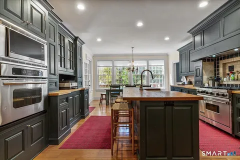 a kitchen with stainless steel appliances granite countertop a stove and a sink