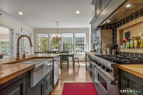 a kitchen with stainless steel appliances granite countertop a stove and a sink