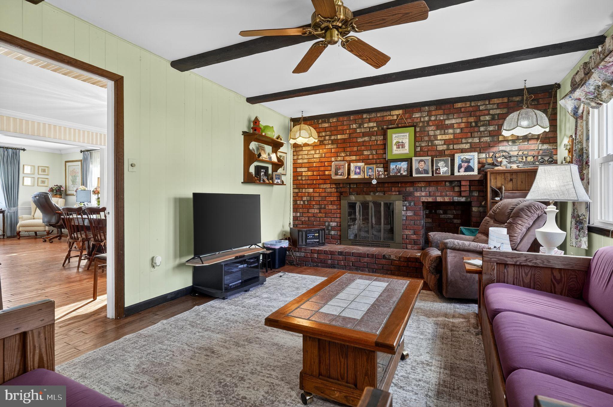 1725 Tarrytown Avenue Crofton, MD 21114 - Photo 20 of 39 a living room with furniture a flat screen tv and a floor to ceiling window