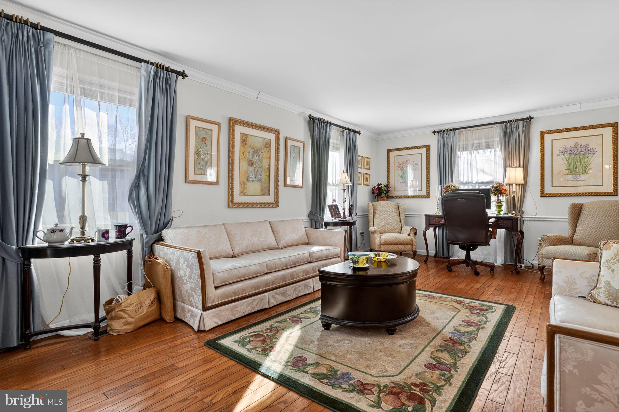 1725 Tarrytown Avenue Crofton, MD 21114 - Photo 7 of 39 a living room with furniture a wooden floor and a large window
