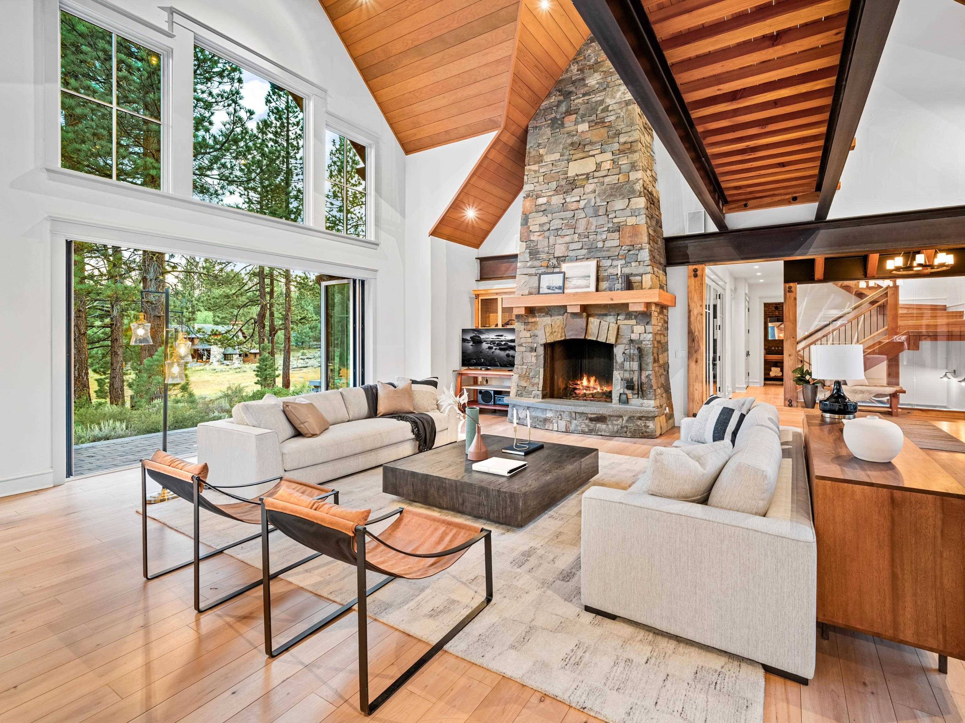 a living room with fireplace furniture and a large window