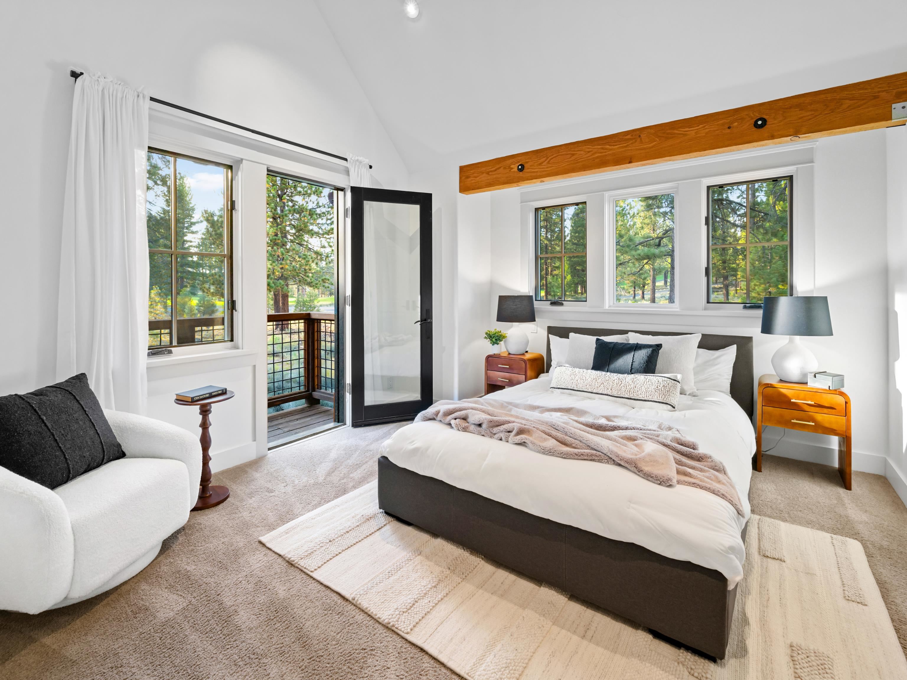 556 Stewart McKay Truckee, CA 96161 - Photo 20 of 27 a spacious bedroom with a bed and a couch next to a window