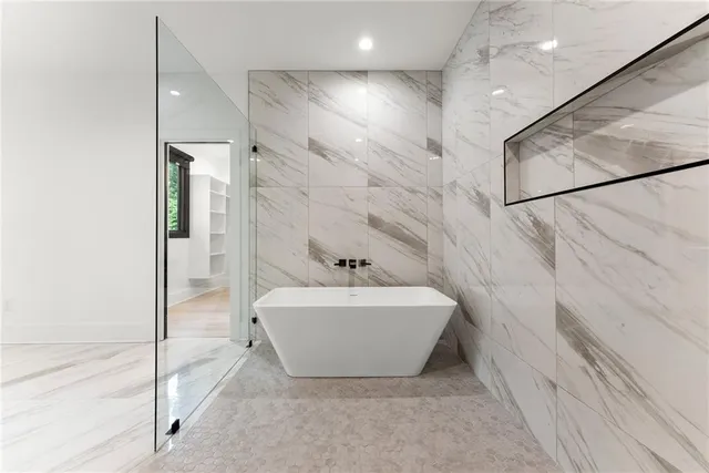 a kitchen with stainless steel appliances a dining table chairs stove and refrigerator