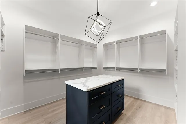 a kitchen with stainless steel appliances granite countertop a stove and a kitchen island