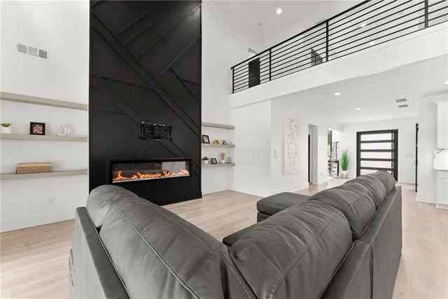 a living room with furniture and wall paintings