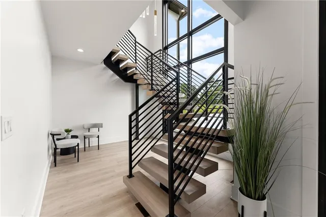 a spacious bedroom with a large bed and a large window