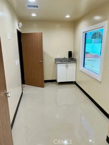 a view of a kitchen with a refrigerator and a window