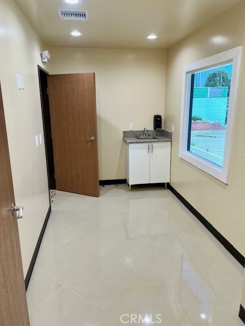 21617 South Figueroa Street Carson, CA 90745 - Photo 6 of 14 a view of a kitchen with a refrigerator and a window
