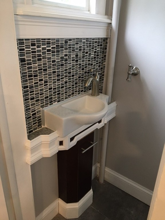 102 Drexel Street Springfield, MA 01104 - Photo 18 of 20 a bathroom with a sink and a mirror