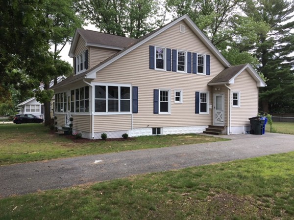 102 Drexel Street Springfield, MA 01104 - Photo 3 of 20 a front view of a house with a yard and garage