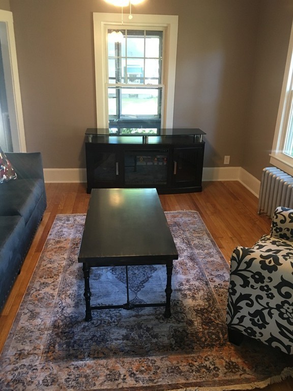 102 Drexel Street Springfield, MA 01104 - Photo 8 of 20 a living room with a couch and a window