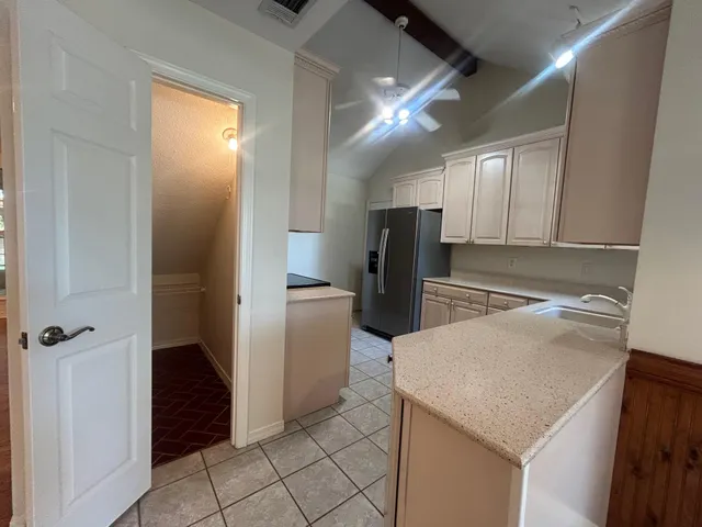 a kitchen with a refrigerator and a sink