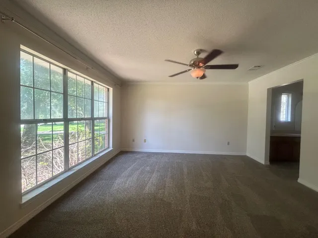 an empty room with windows and closet