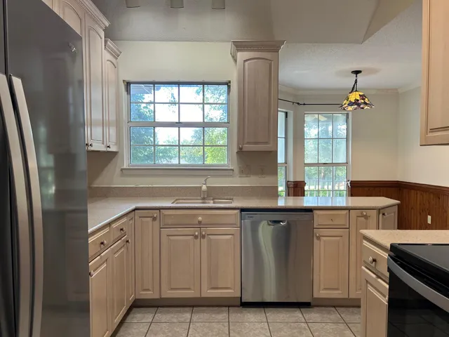 a kitchen with white cabinets and white appliances