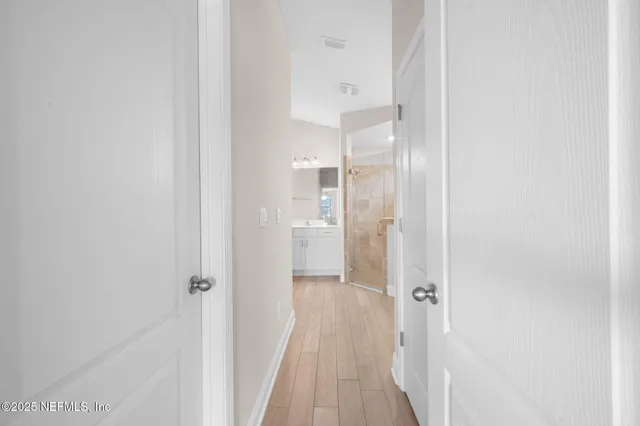 a bathroom with a double vanity sink mirror and shower