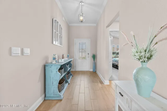 a spacious bedroom with a bed and a chandelier