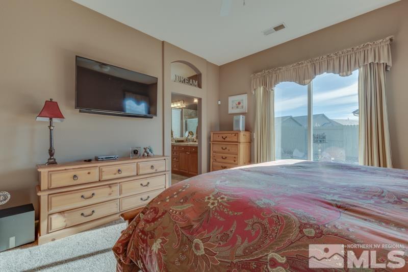 1696 Ghettis Way Reno, NV 89521 - Photo 16 of 25 a bed room with a bed and a television