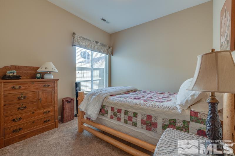 1696 Ghettis Way Reno, NV 89521 - Photo 18 of 25 a bedroom with a bed and a window