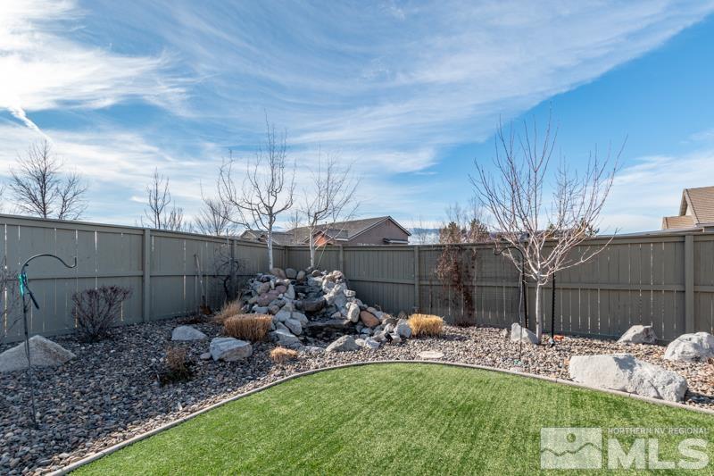 1696 Ghettis Way Reno, NV 89521 - Photo 21 of 25 a backyard of a house with table and chairs