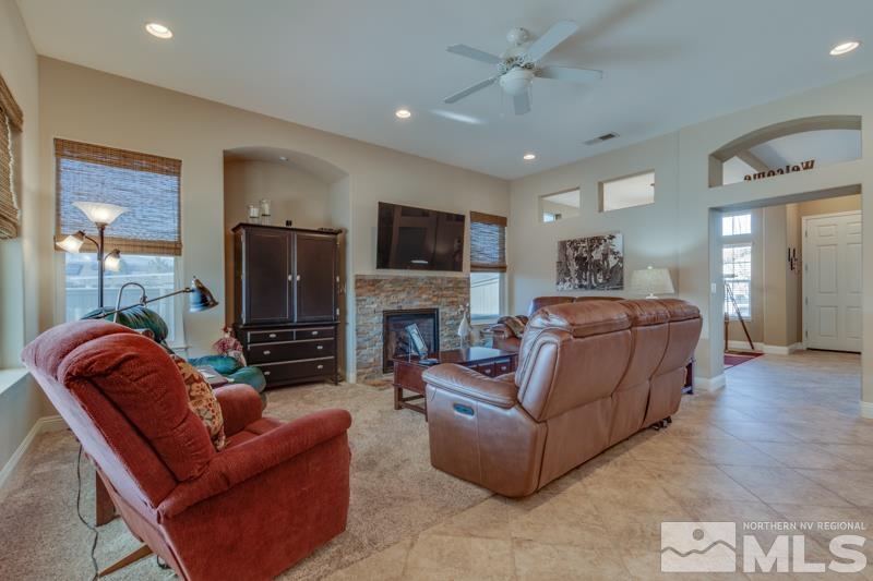 1696 Ghettis Way Reno, NV 89521 - Photo 8 of 25 a living room with furniture a fireplace and a flat screen tv
