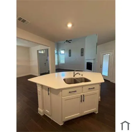 a view of empty room with ceiling fan