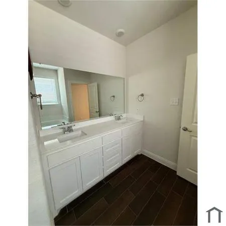 a view of an empty room with a ceiling fan