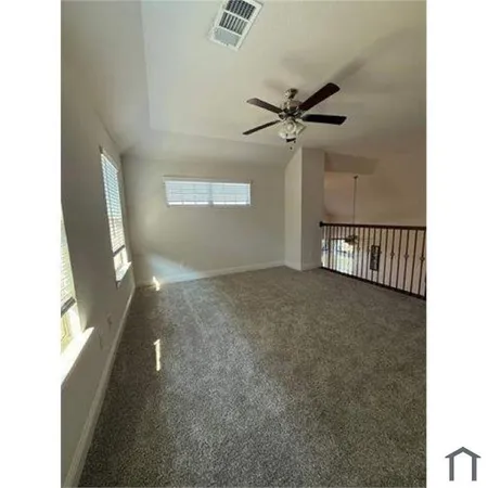 a view of a hallway with a large window and couch