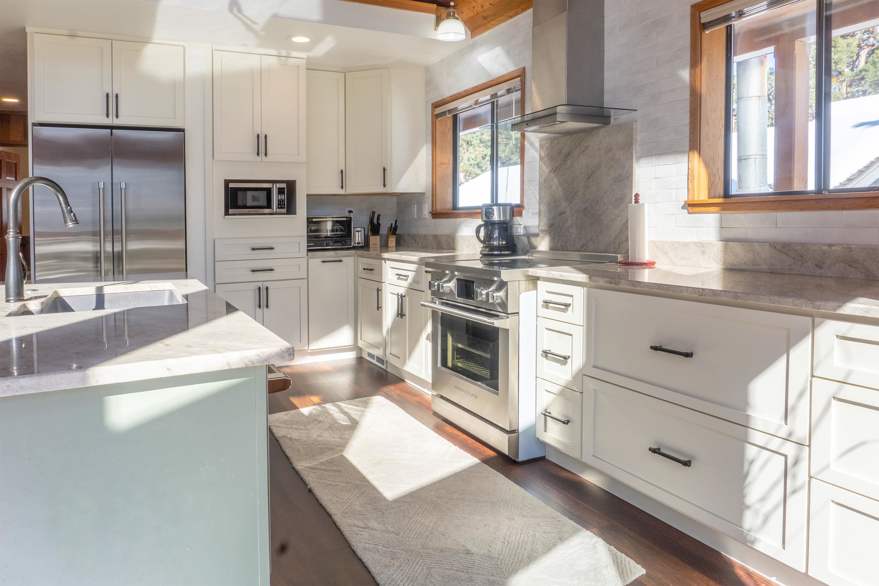 179 Washington Street June Lake, CA 93529 - Photo 12 of 49 Kitchen featuring light stone counters, dark wood-style flooring, and high quality appliances