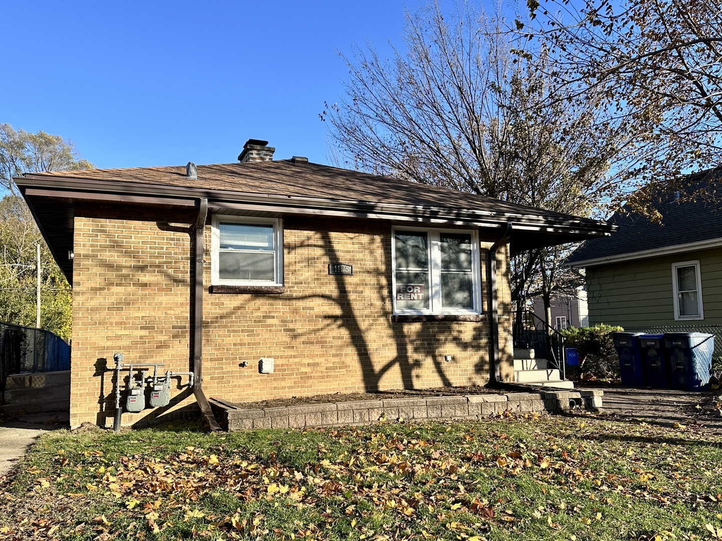 a view of house with backyard and furniture
