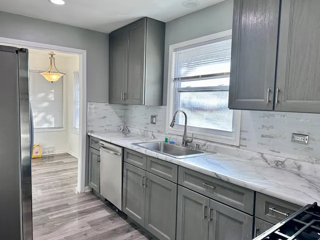 a kitchen with a sink and cabinets