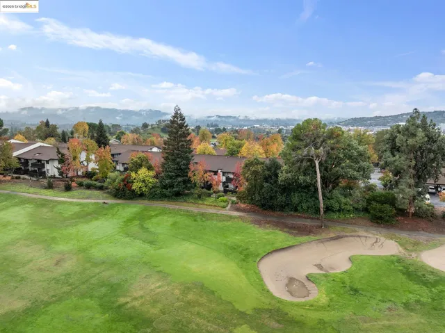 a view of a big yard with table and chairs