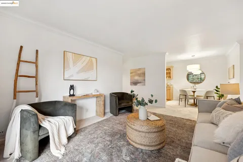 a dining room with furniture and mirror