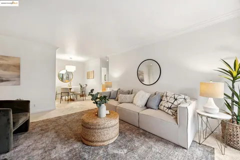 a kitchen with stainless steel appliances a table chairs and chandelier