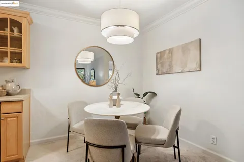 a living room with furniture a fireplace and a chandelier