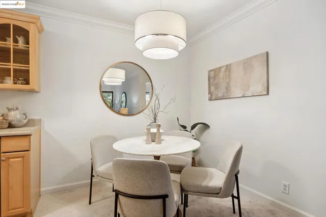 a living room with furniture a fireplace and a chandelier