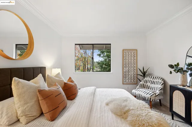 a bedroom with bed and a chandelier