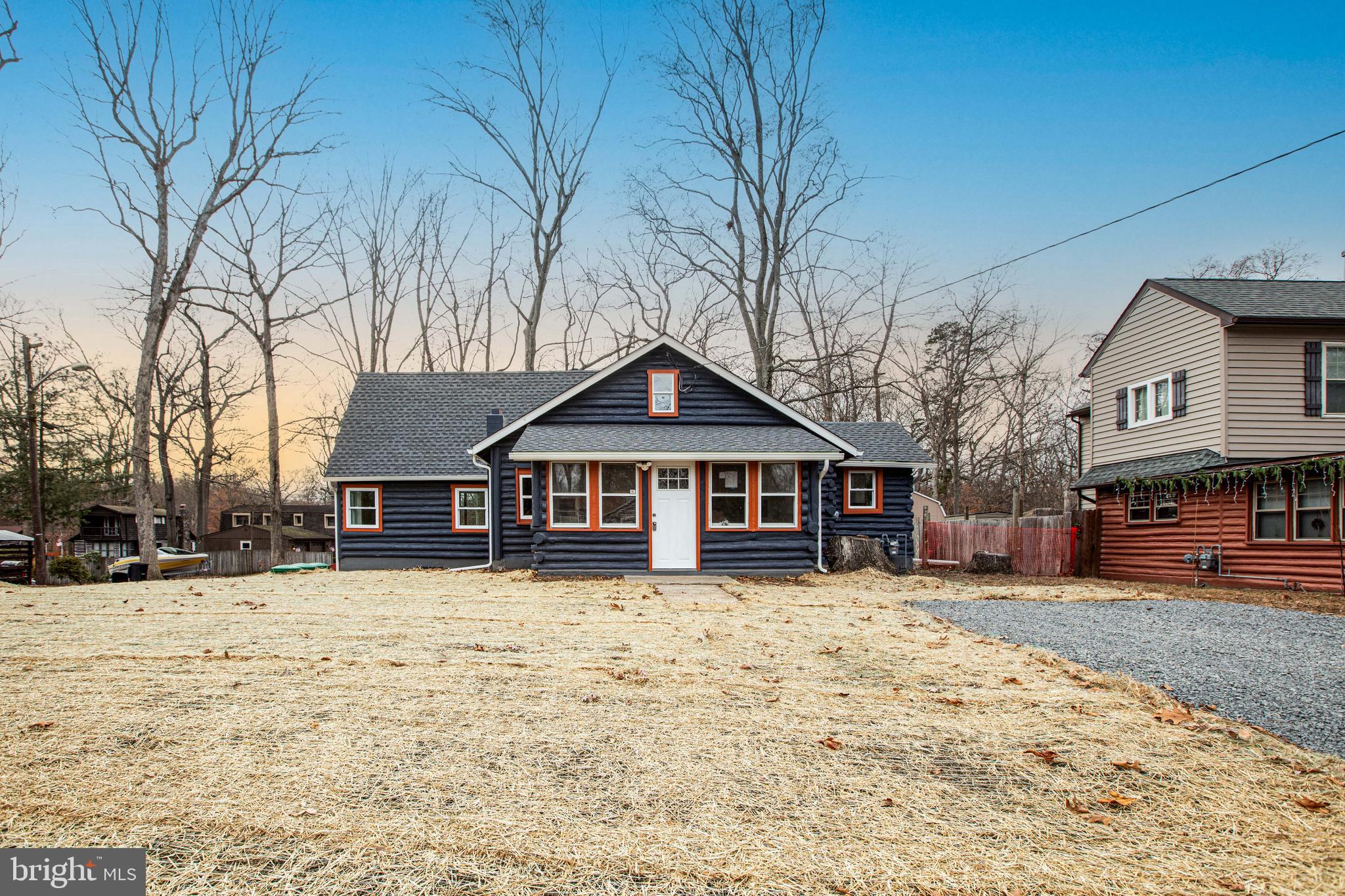 a view of a house with a yard covered in snow