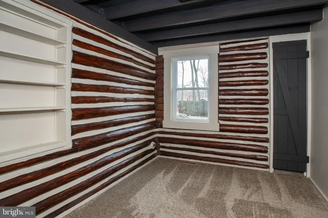 a view of a room with a window and a door