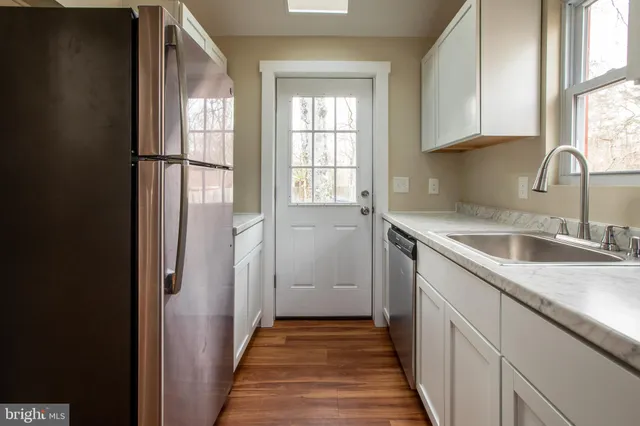 a kitchen with a sink and a window