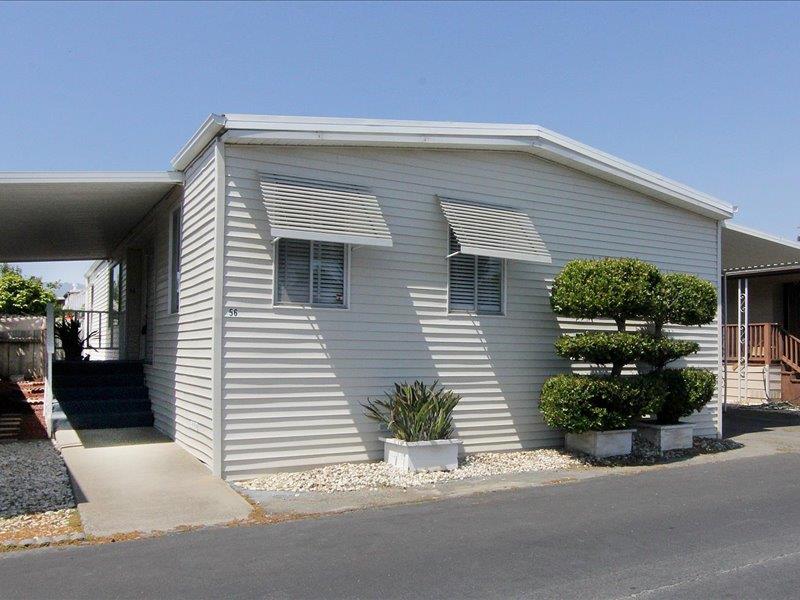 a view of a house with a small yard and plants