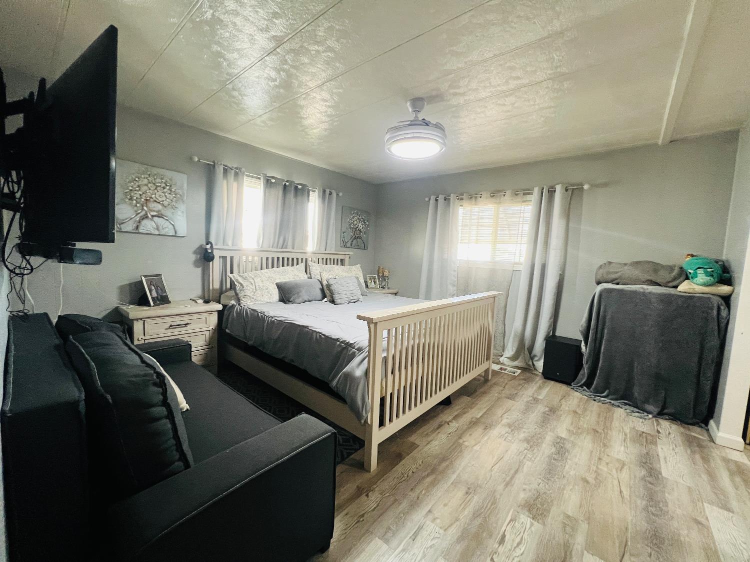 2845 East E Hatch Road, Unit 86 Ceres, CA 95351 - Photo 21 of 32 a bedroom with furniture and a flat screen tv