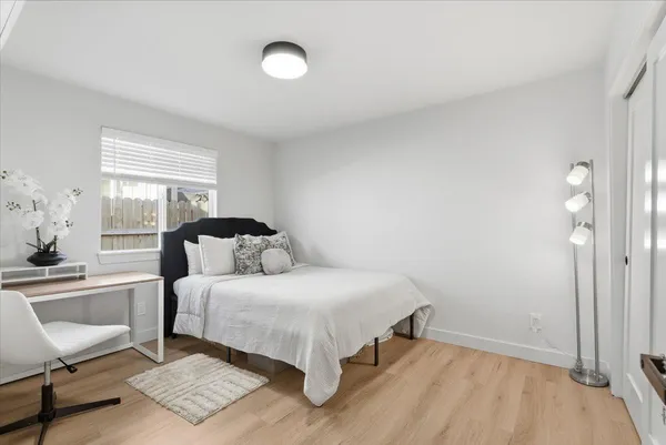 a bedroom with a bed and a chair