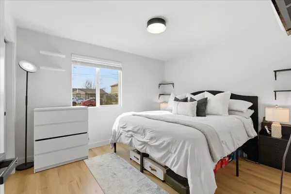 a bedroom with a bed and a window
