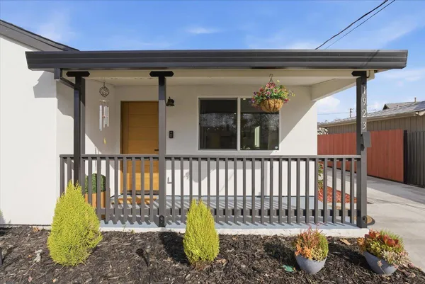a front view of a house with a garden